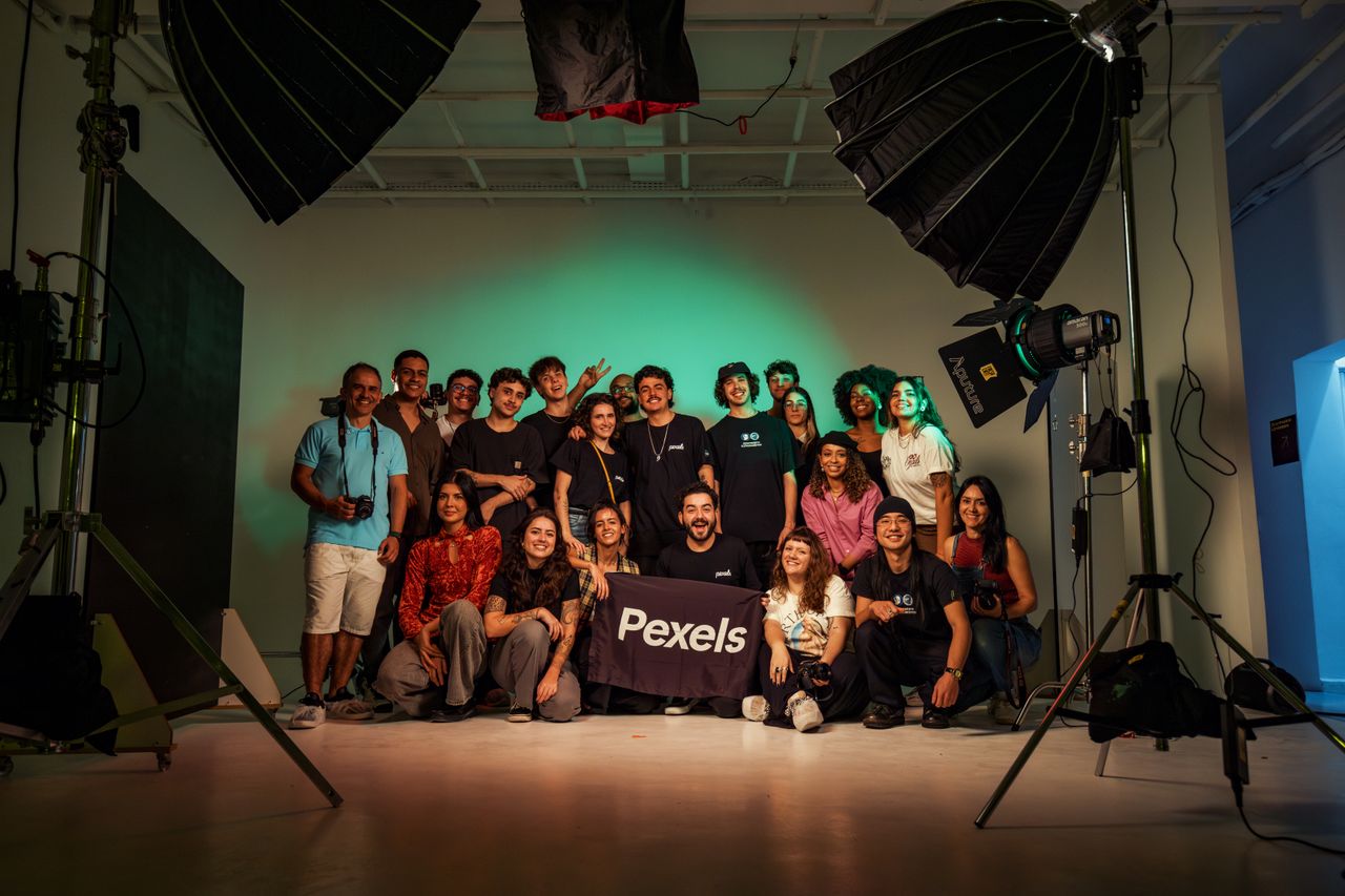 A diverse group of adults posing in a professional photography studio.